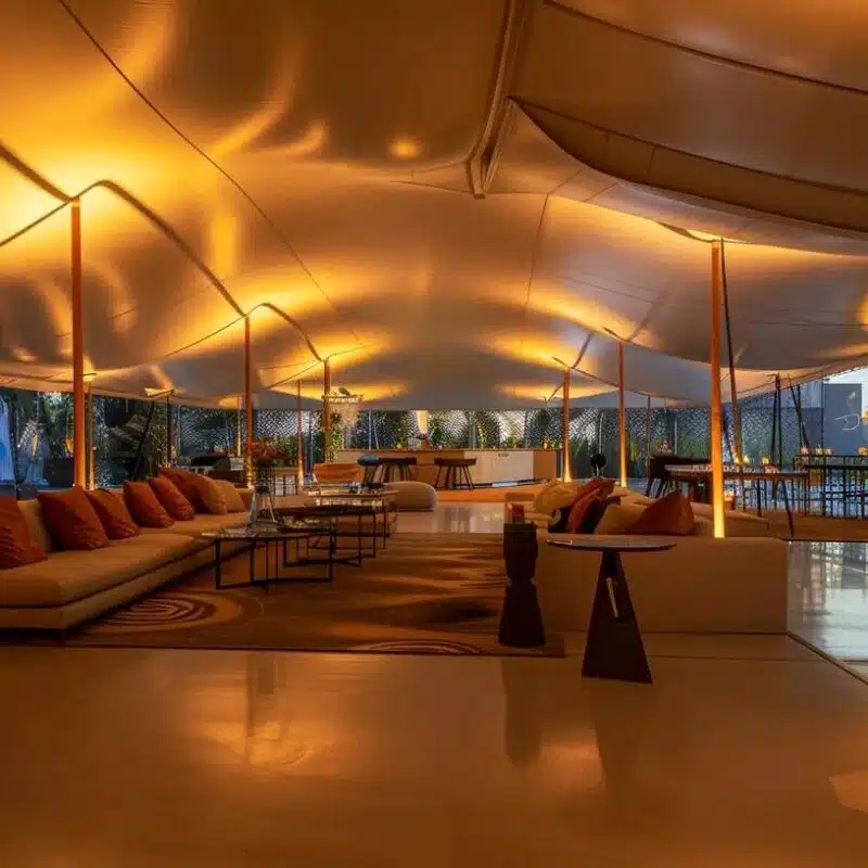 a sleek and modern indoor setting showcases a sophisticated sailcloth tent, illuminated by ambient lighting, with visible condensation patterns highlighting the importance of understanding moisture management for tent owners.