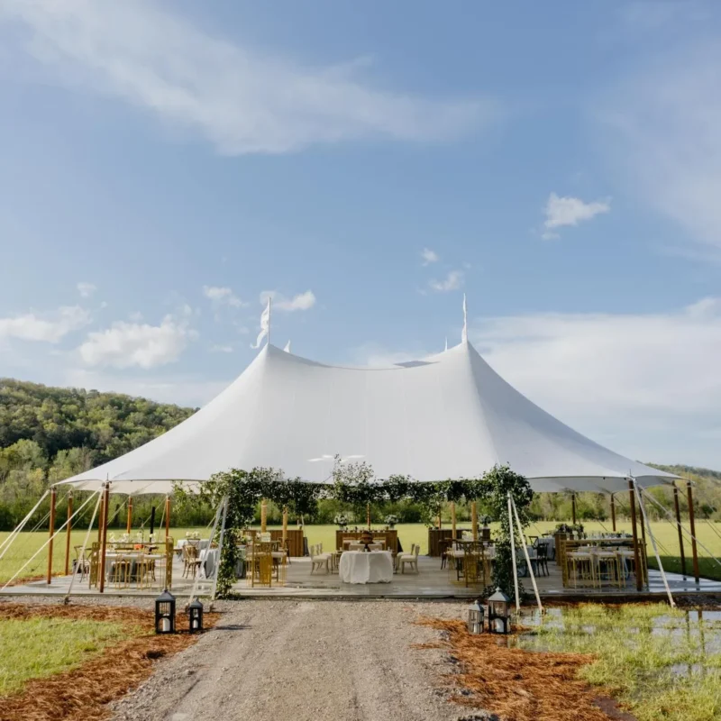 Sailcloth tent on soft, muddy ground.
