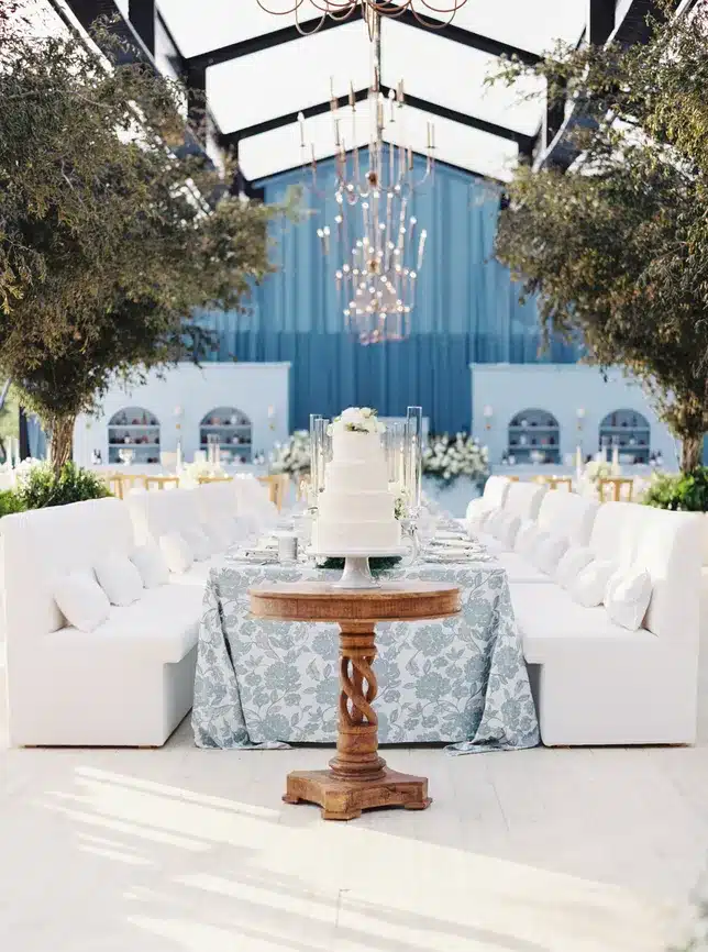 Elegant wedding setup under a frame tent featuring engineered flooring, ambient chandeliers, and climate-controlled comfort for upscale event enhancement.