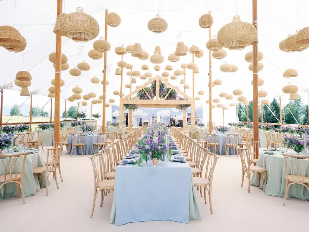 Century Pole Tent with multiple center poles and staked perimeter lines, illustrating more complex installation compared to freestanding frame tent setups.