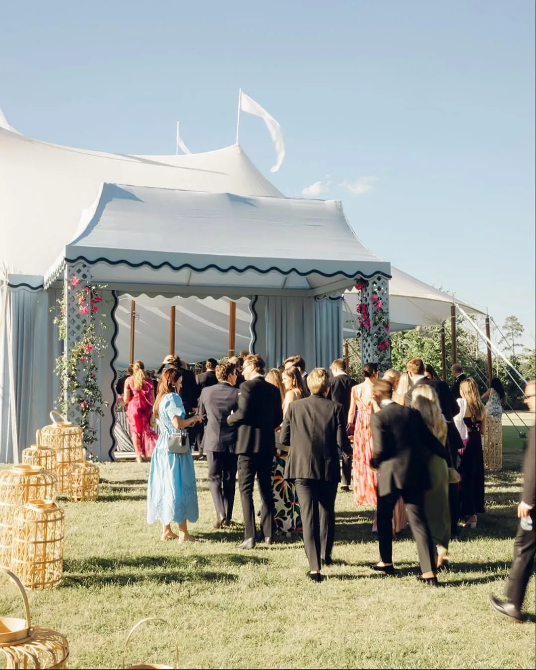 Guests arriving at a decorated event tent entrance