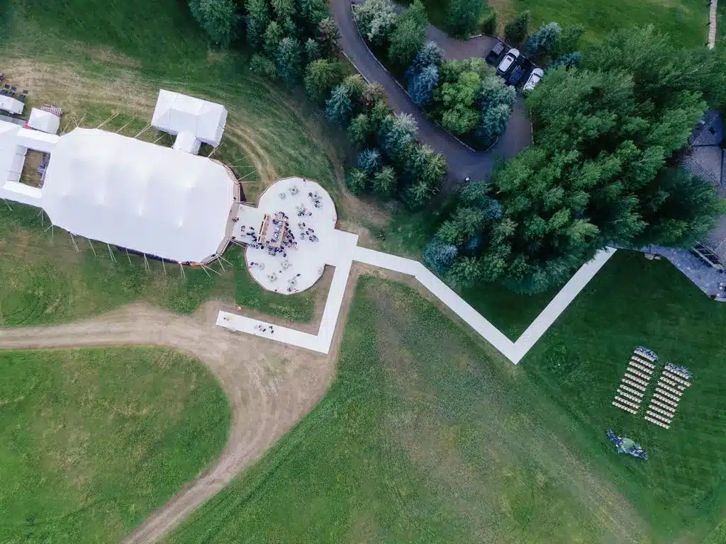 Aerial view of a high peak tent with outdoor event seating.