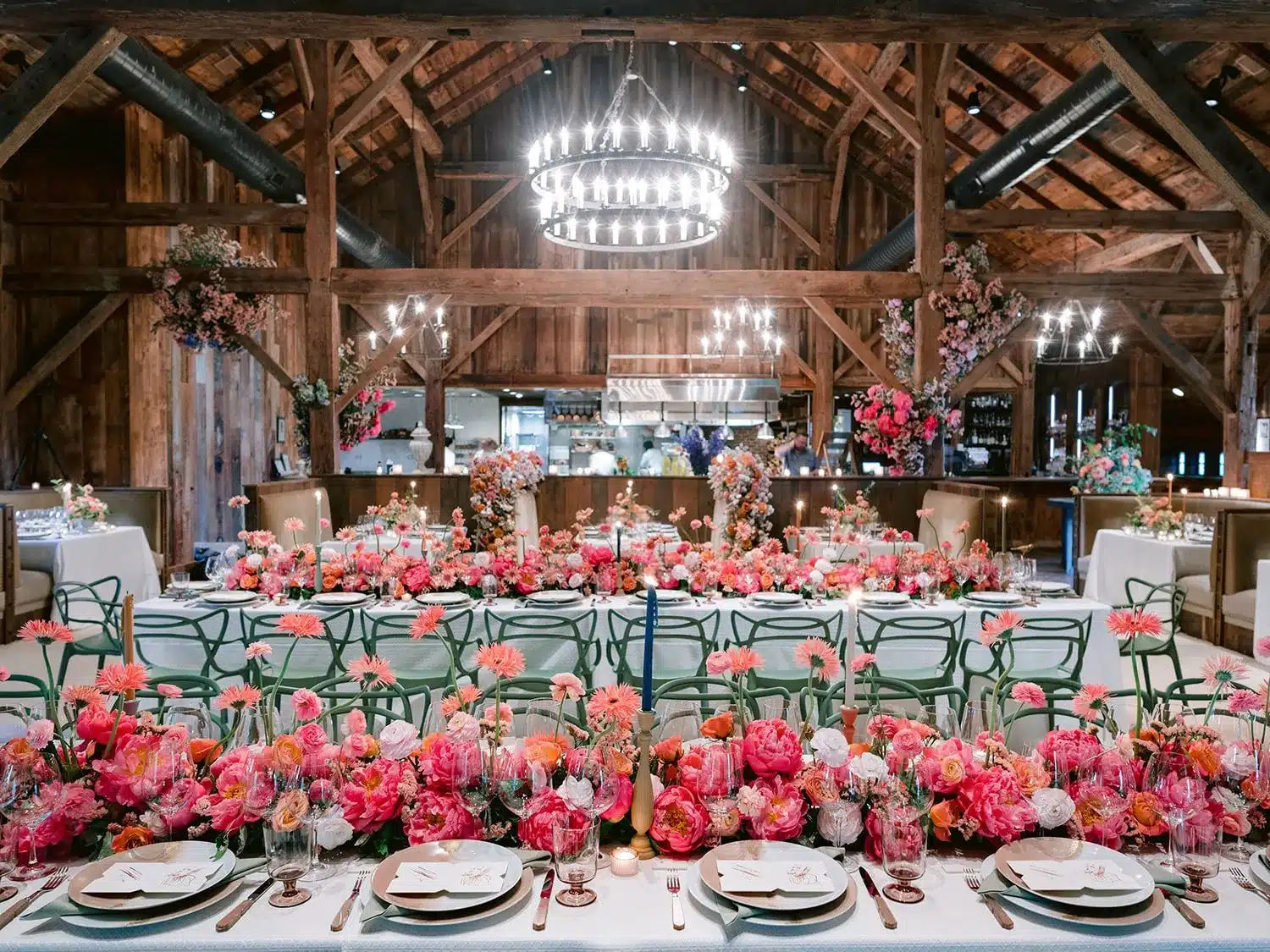 Rustic barn wedding reception with vibrant floral décor