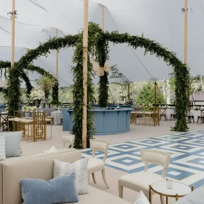 Tent floral design with greenery ceiling arches and modern seating