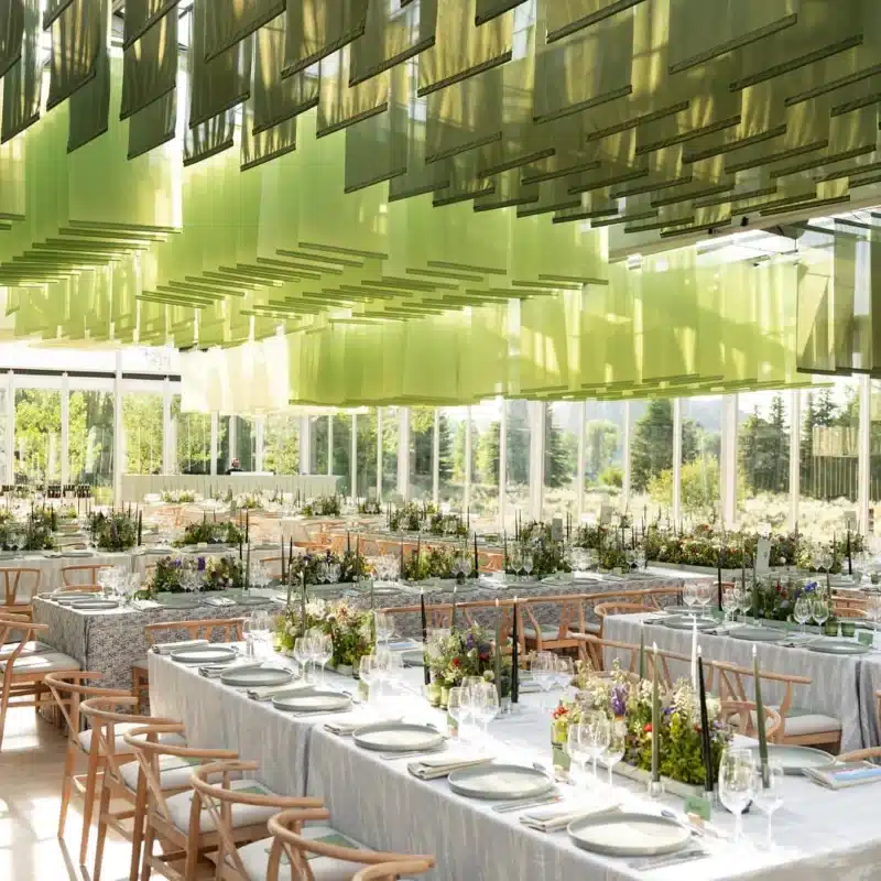 Long banquet tables with greenery-inspired ceiling
