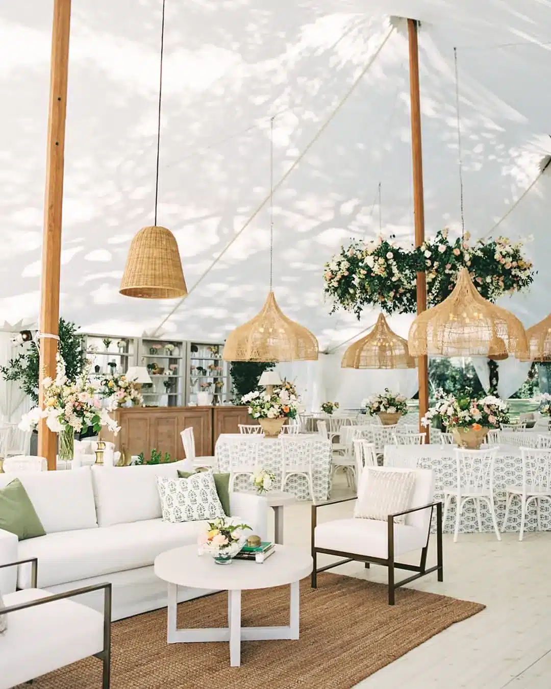 Luxury sailcloth tent lounge with bar, woven pendant lights, and soft seating.