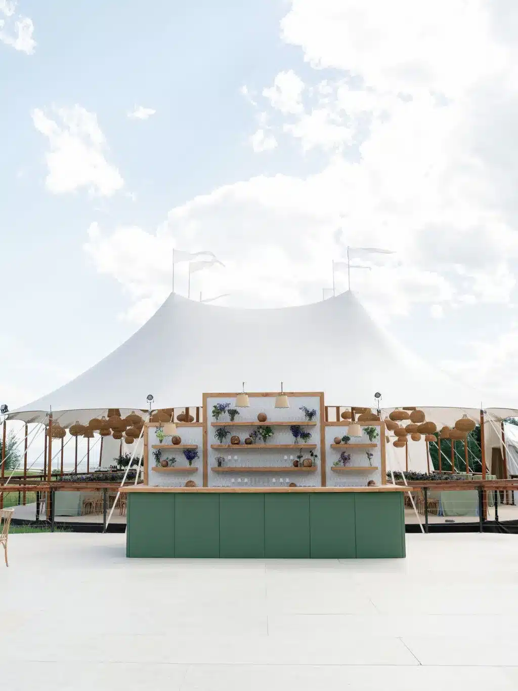 Wide backyard party tent with a full bar setup, illustrating tent size needed for food and beverage service.