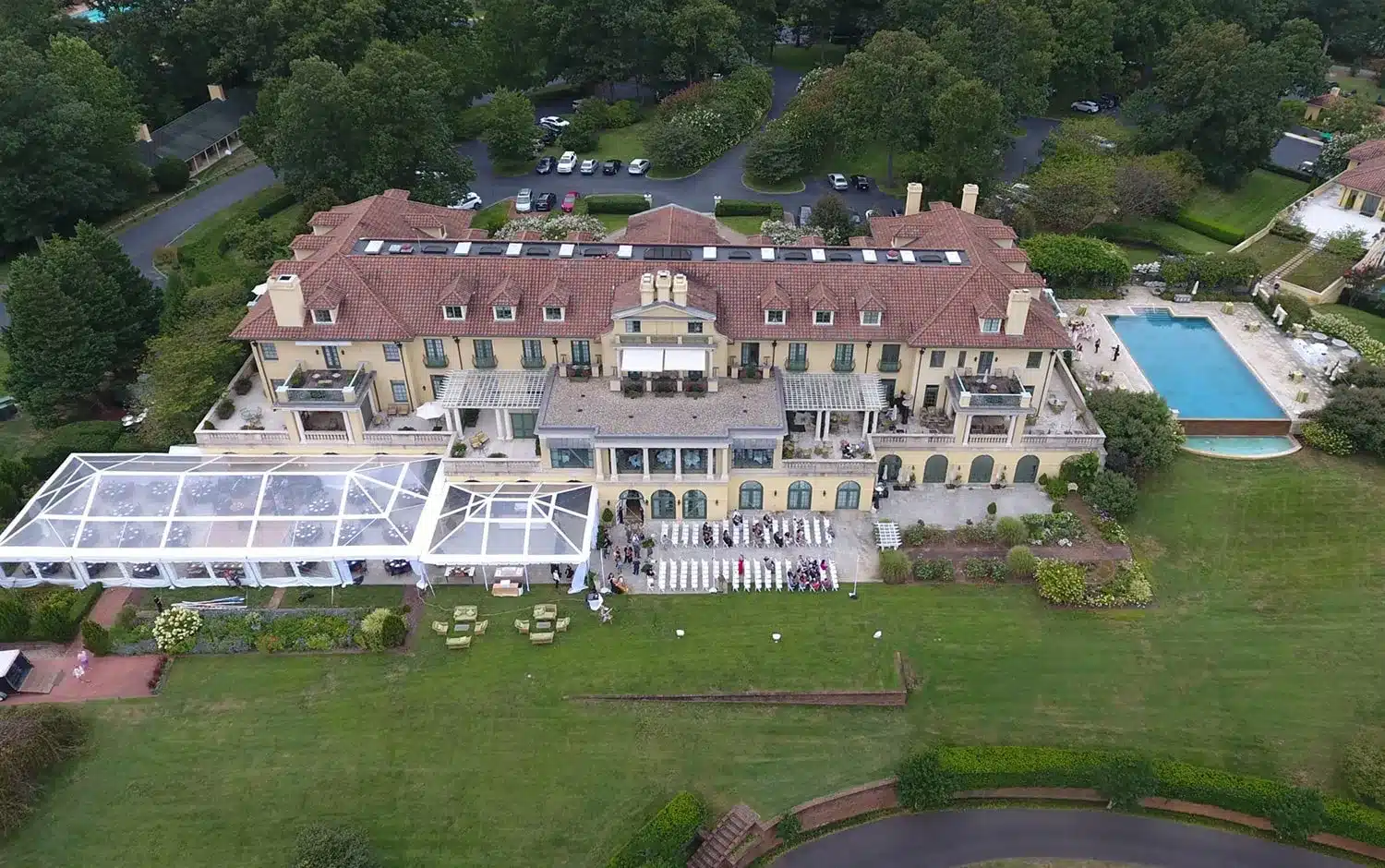Aerial view of a large estate with multiple event tents installed on the grounds