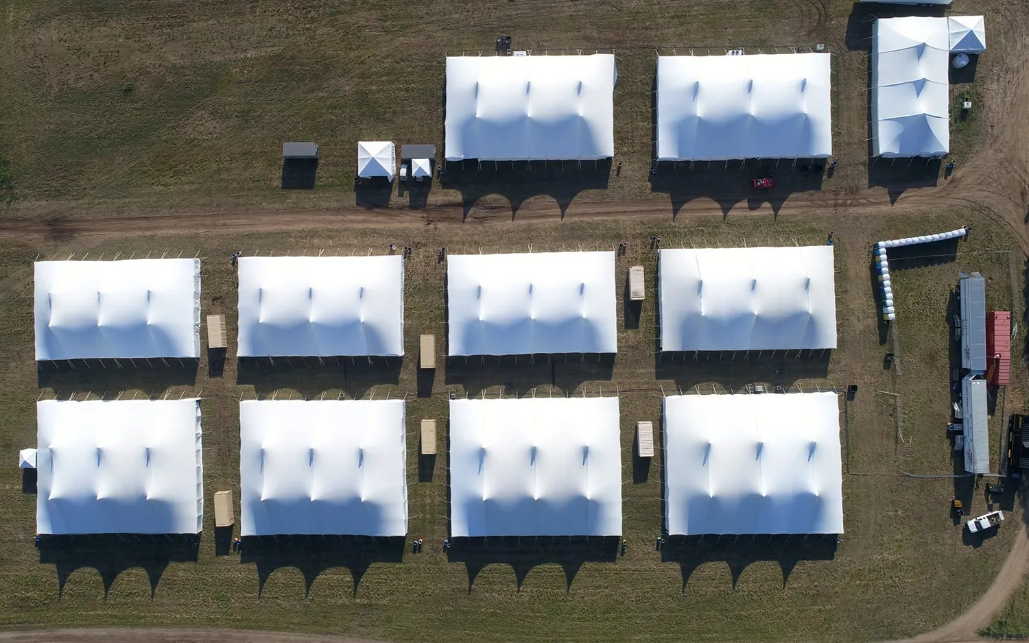 Aerial view of multiple event tents illustrating layout planning for large summer beach wedding celebrations