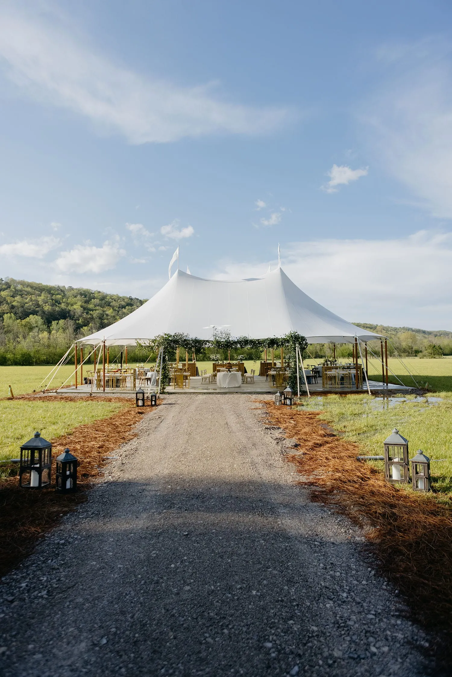 Spacious sailcloth wedding tent sized for summer reception with ample guest seating and layout planning