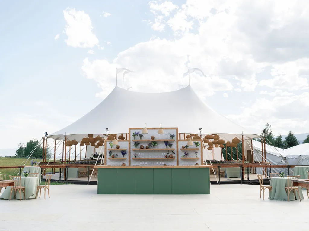 Evening wedding dance floor inside tent with ambient lighting enhancing layout visibility and guest experience