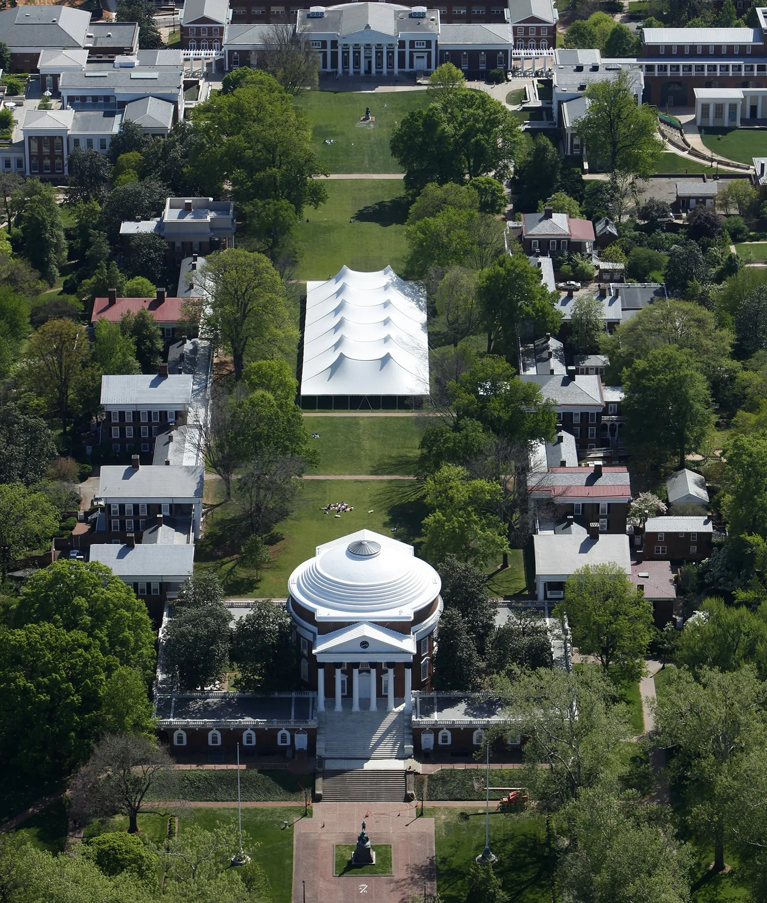 Aerial view of campus lawn with large event tent showing how open spaces accommodate backyard tent wedding setups