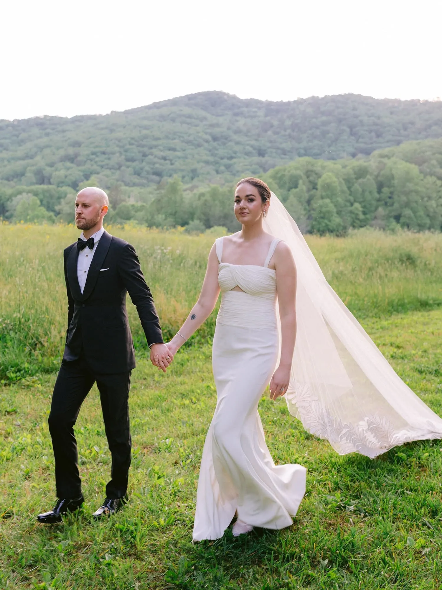 Soft evening wedding lighting for outdoor portraits near luxury tent reception setting