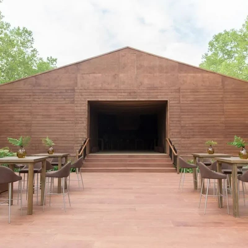 Custom wood flooring deck for outdoor wedding tent with elevated platform and modern lounge seating