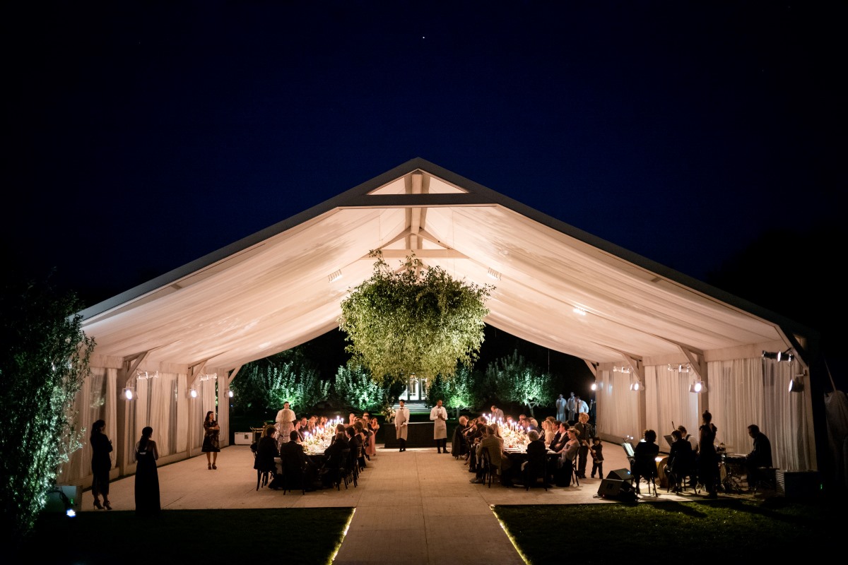 Guests gathering under a with glowing chandeliers