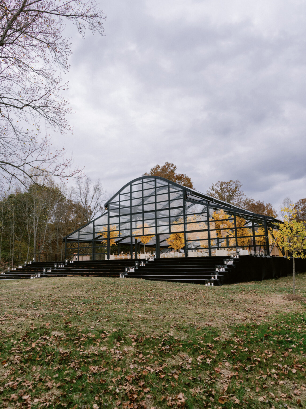 Tent structure with raised flooring and stairs, supporting event infrastructure and accessibility.