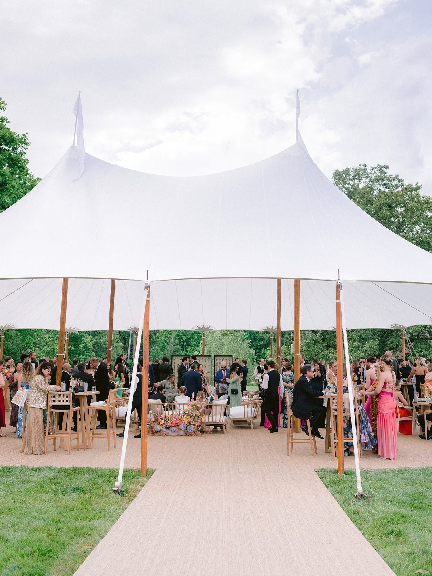 Outdoor corporate tent for summer event with lounge and networking areas