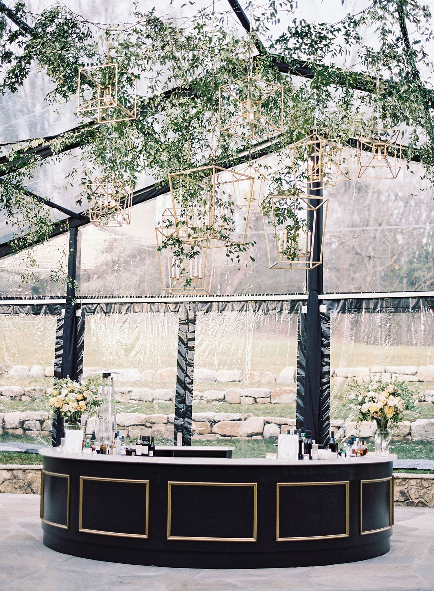 Premium summer tent rental with banquet tables and ambient lighting