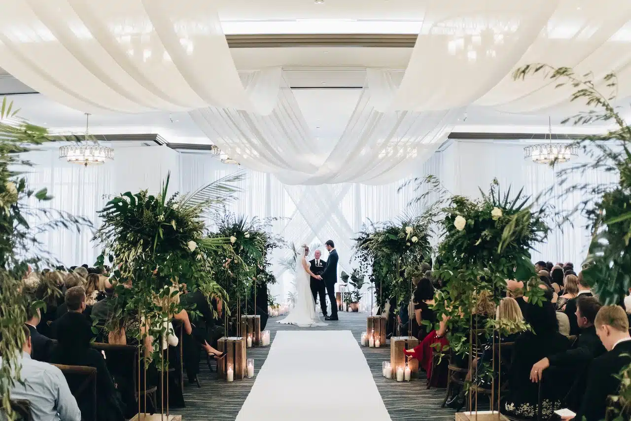 Elegant garden wedding tent illuminated with luxury chandelier lighting