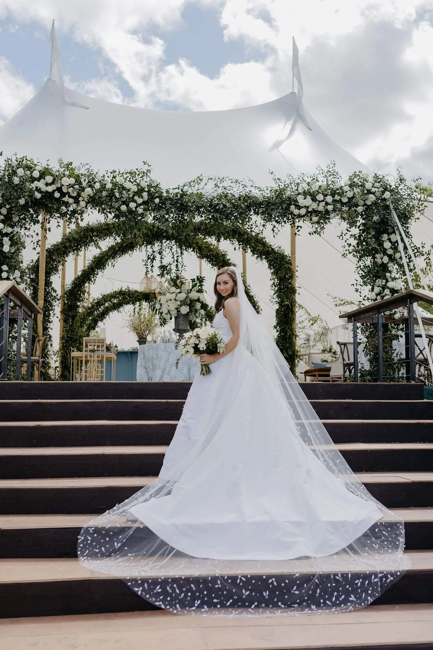 Luxury outdoor wedding reception under a weather-proof event tent