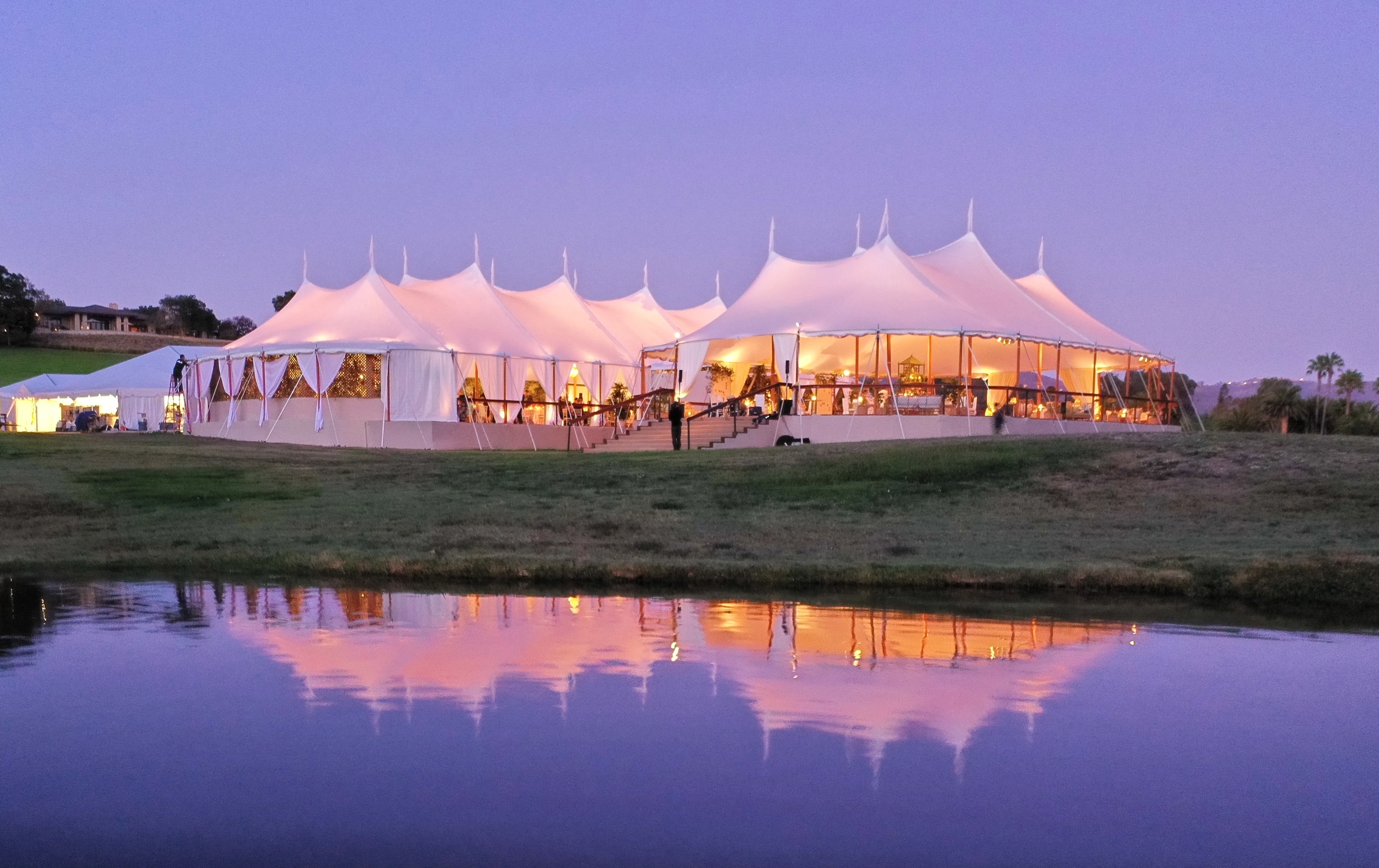 Outdoor autumn wedding venue featuring weather-resistant tent rental